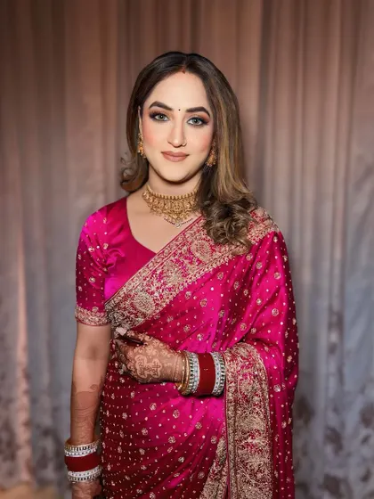 Reception ready in a beautiful pink saree. The makeup is soft and romantic, with a focus on glowing skin.
