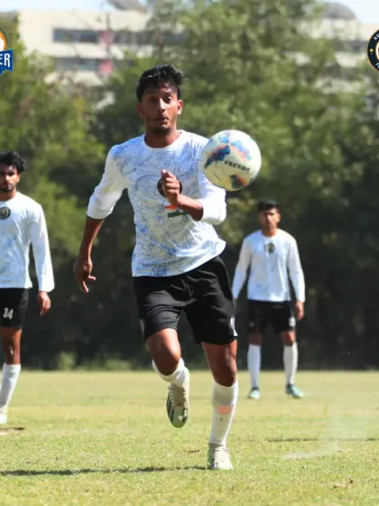 A player receiving the ball, showcasing good first touch and awareness of the players around them.