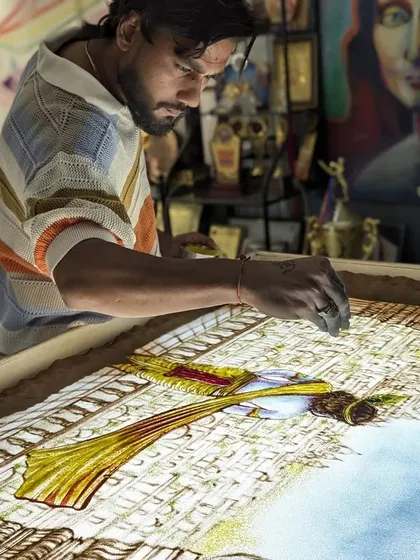 In my studio, working on a detailed sand art piece of Lord Krishna. This colorful creation is for an upcoming project that I am very excited about.