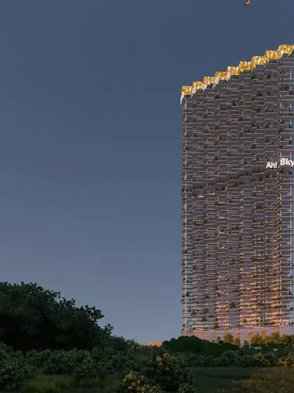 The "Ah! Sky!" tower at dusk. The 52 storey project, with its rich mix of retail and restaurants, is designed to be a landmark. The unique silhouette and illuminated crown make it a beacon in the city skyline.