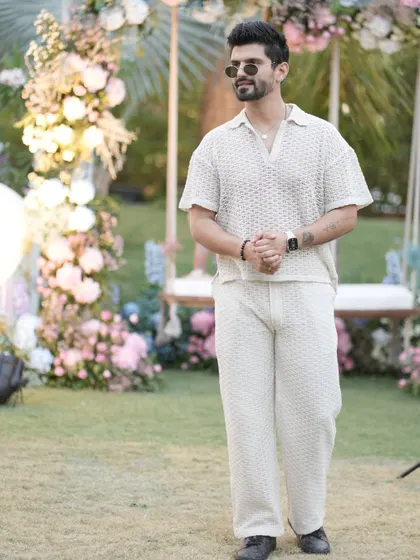 A full-length view of the knitted co-ord set. It's a comfortable yet fashionable choice for a daytime event.