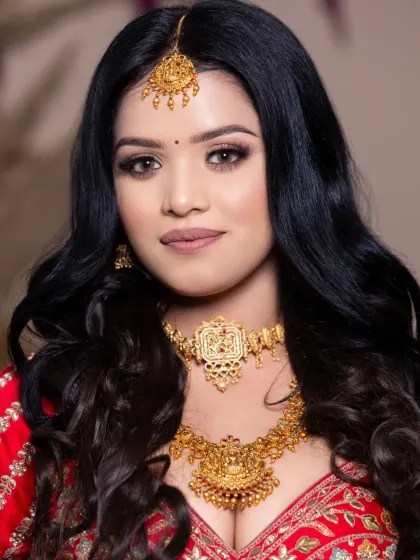 A close-up of this South Indian inspired bridal look, showcasing the intricate gold jewelry and warm-toned makeup.