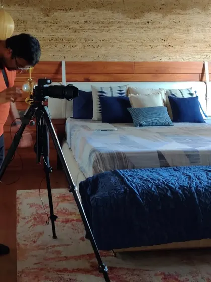 Behind the scenes of a photoshoot, capturing the final look of this stunning primary bedroom.