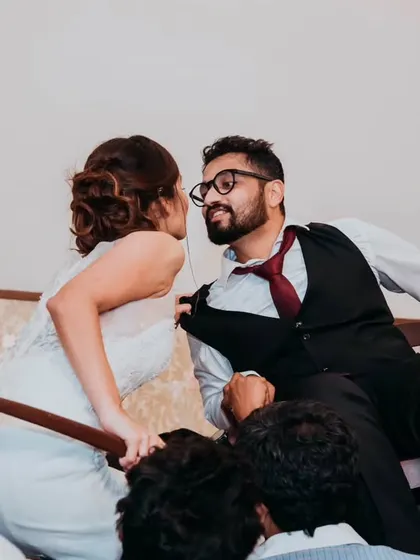A playful moment during the reception, where the bride and groom are lifted on chairs for a traditional Jewish wedding dance, the Hora. We love capturing these unique cultural celebrations.