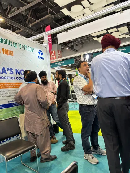 A group of visitors gathers to learn about solar subsidy benefits at our stall. We ensure everyone understands the financial advantages of switching to a solar rooftop system.