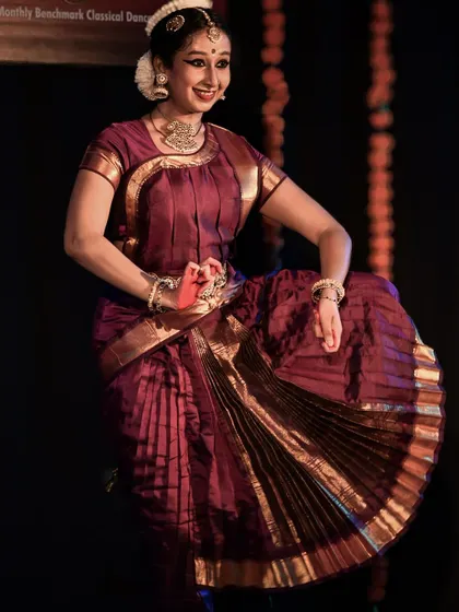 The dancer's graceful pose and joyful expression during her performance.