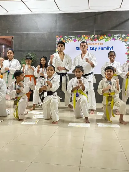 Our medal winners from the Silicon City dojo strike a powerful kamae (ready stance) pose. They fought with great spirit and represented our dojo with pride.