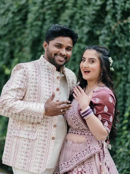 A fun, candid shot capturing the couple's excitement as they show off the new engagement ring, full of personality and joy.