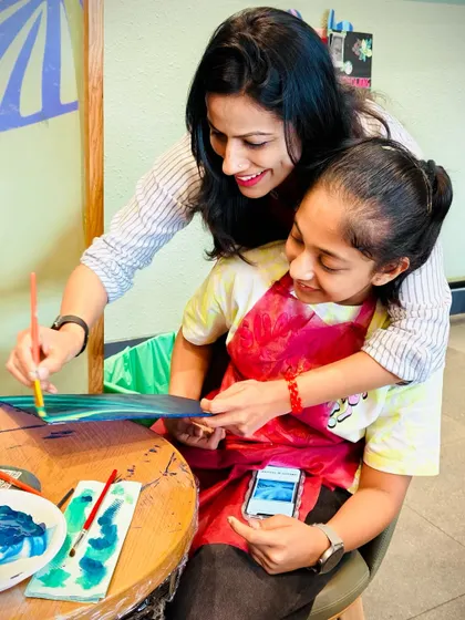 A mother and daughter bonding over a Northern Lights painting. Art is a wonderful way to connect and create lasting memories.
