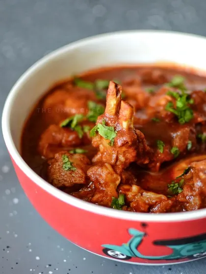 A close-up of our signature Kashmiri Rogan Josh. We slow-cook tender mutton in a rich, aromatic gravy with authentic spices. This dish is a testament to our passion for gourmet North Indian cuisine, delivering deep flavor without being overly spicy.