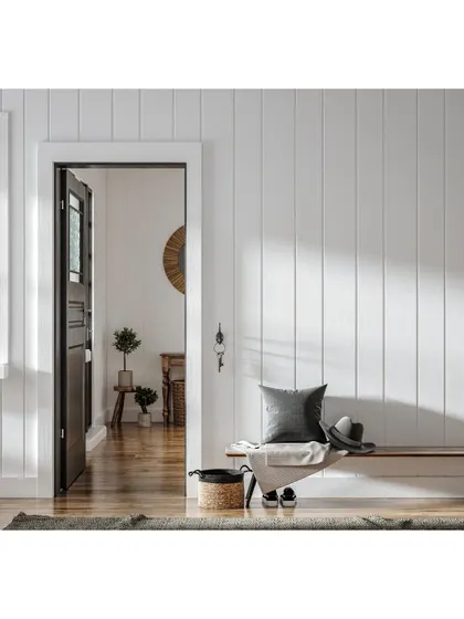An entryway sets the tone for the entire home. Here, we used vertical shiplap paneling and a simple wooden bench to create a clean, welcoming, and modern farmhouse-style first impression.