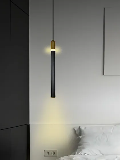 A sleek, black and gold pendant light, perfect for modern bedside lighting.