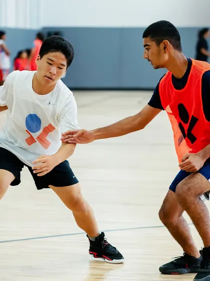 One-on-one action in our youth program, where players learn both offensive and defensive skills.