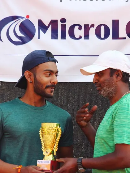 The winner, Yash Yadav, receives his trophy and some words of encouragement from our head coach after the MicroLogix Men's 50k final.