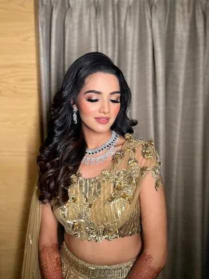 A close-up of Mahek's sangeet makeup, with her eyes closed to showcase the beautiful blend of gold and bronze eyeshadow.