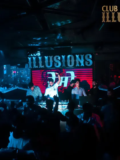 A wide view of the stage at Club Illusions, with my name in lights. This shot establishes my presence as the main act of the night.
