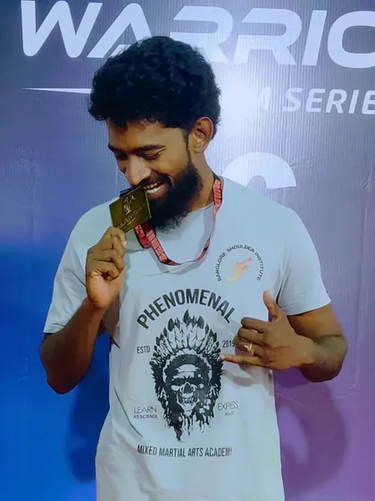 A moment of celebration after securing a gold medal at the Warrior's Dream Series. I lead by example, competing alongside my students.