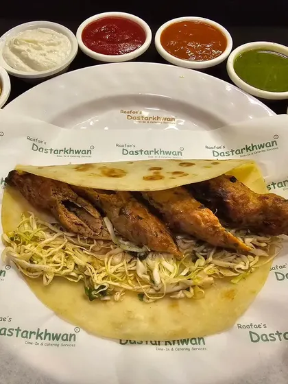 My classic Seekh Kebab Roll. Tender mutton seekh kebabs are wrapped in a soft paratha with shredded cabbage and served with seven different dips, from spicy to creamy.