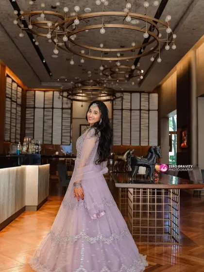 A dreamy reception look in a lavender lehenga. The makeup features soft pink and purple eyeshadow with a subtle lip, paired with diamond jewelry for a touch of sparkle.