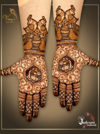 This unique design features birds perched on a kalash on the arms, with swans inside a central medallion on the palms. The surrounding texture is made of fine, swirling patterns.