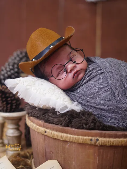Swapping the cap for a cowboy hat, this little one is ready for a different adventure. I love mixing and matching props to create unique looks.