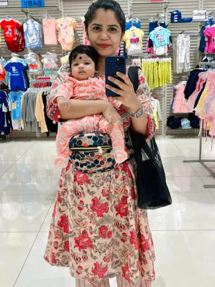 Shopping for baby clothes with my little one. The hip seat carrier is a must-have for any shopping trip with a baby.