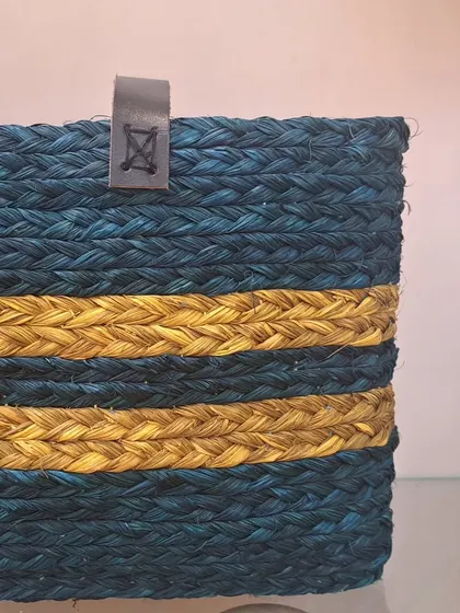 A close-up of our two-tone basket, showing the rich blue and yellow stripes and the small leather tab detail. This highlights the quality and attention to detail in our products.