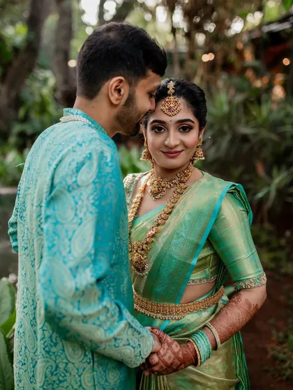 A tender moment between the couple, showcasing their beautiful coordinated outfits. Our goal is to capture the subtle emotions and details that make your wedding portraits special.