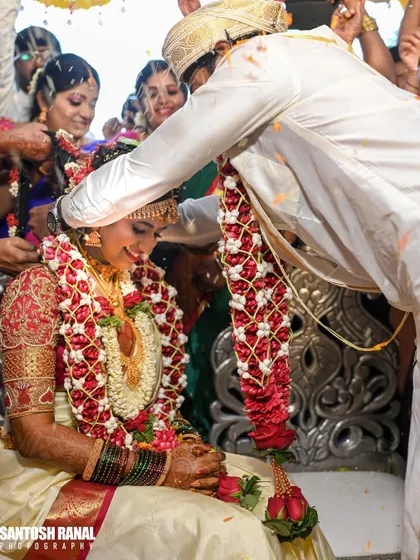 The significant moment of the groom tying the garland, a key part of the wedding rituals.