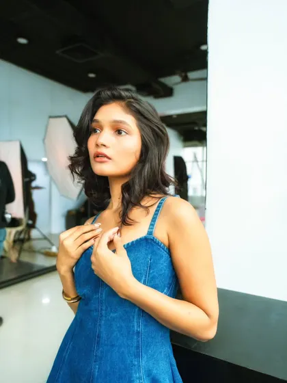 Here you can see the model in a thoughtful pose, with the studio's lighting equipment visible in the background. This image is a great example of the "creative chaos" I love to capture in my BTS work.