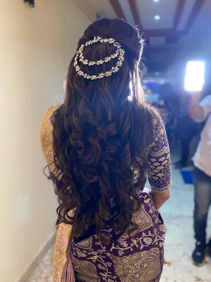 A half-up style with voluminous curls, adorned with a sparkling double-chain hair accessory. This adds a touch of modern glamour to the look.