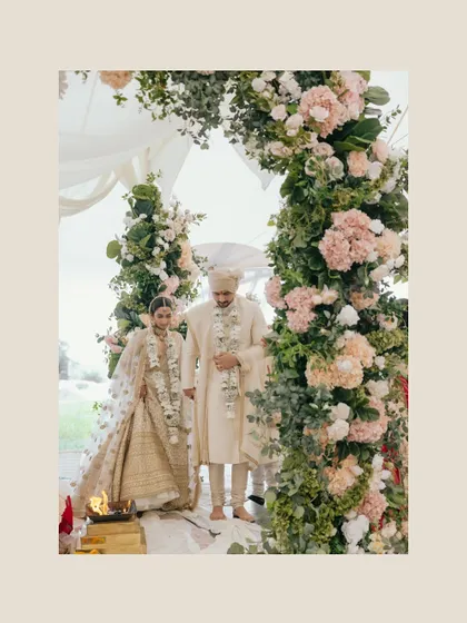 The sacred fire of the wedding ceremony, with the couple framed by a stunning floral arch. This shot combines tradition with beautiful, modern decor.