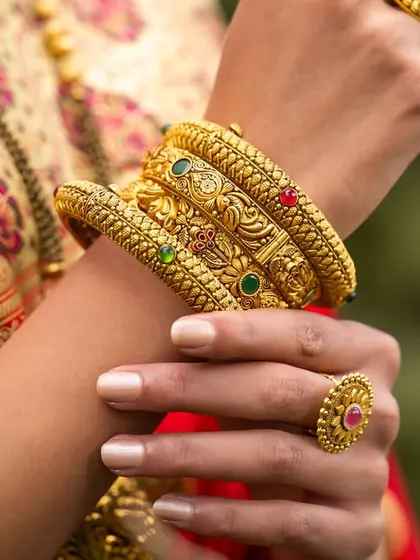 A detailed macro shot of the intricately designed gold bangles, demonstrating my ability to capture product details.