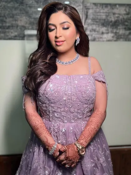 For this reception, I styled the bride's hair in beautiful, flowing waves that complement her off-shoulder lavender gown.