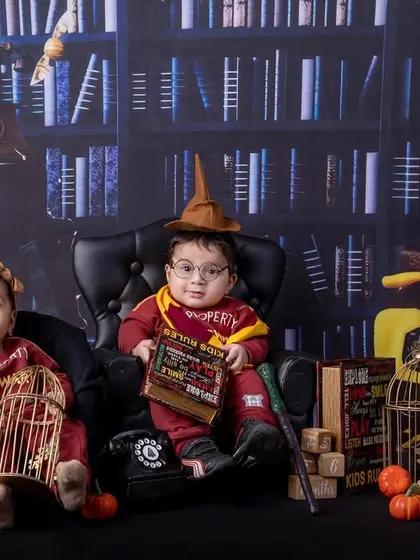 Double the magic! A pair of twins dressed in Harry Potter outfits for their six-month sitter session.