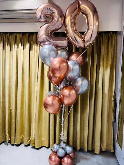 Turning 20 in style with this gorgeous rose gold and silver balloon bouquet. The large number balloons make a huge statement for any milestone birthday.