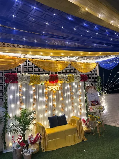Another view of the terrace Haldi setup, showing the combination of the starry blue ceiling drapes and the bright yellow seating area.
