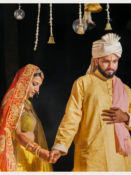 The couple holding hands during their wedding ceremony, a simple yet powerful gesture of connection and commitment.