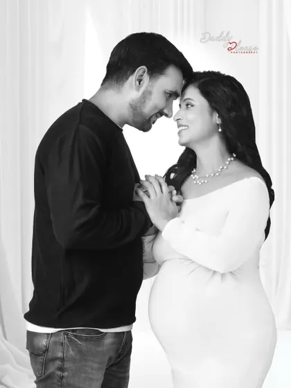 An intimate black and white close-up of a couple during their outdoor maternity shoot. This photo captures the love and excitement between them in a timeless format.