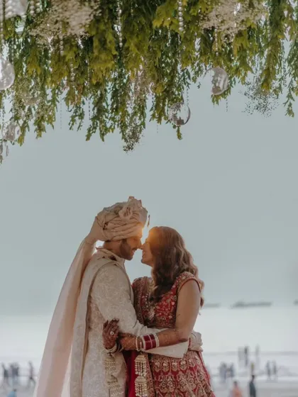 A breathtaking shot of the bride and groom. The silhouette against the setting sun is incredibly romantic, and her mehendi is a part of this picture-perfect moment.