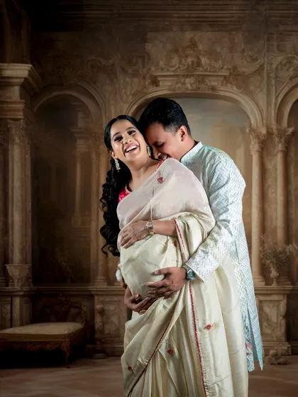 We love capturing the connection between partners. This candid moment was taken in our studio, showcasing how we can create a warm, intimate atmosphere for a traditional maternity photoshoot with a classic, painterly backdrop.