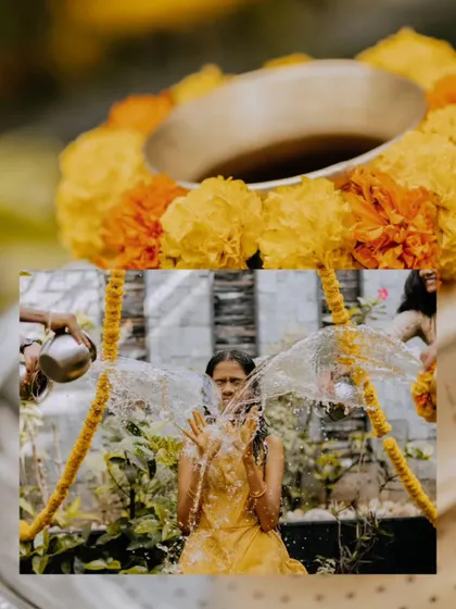 An artistic shot of a young woman during her Mangala Snaanam, with water splashing around her.
