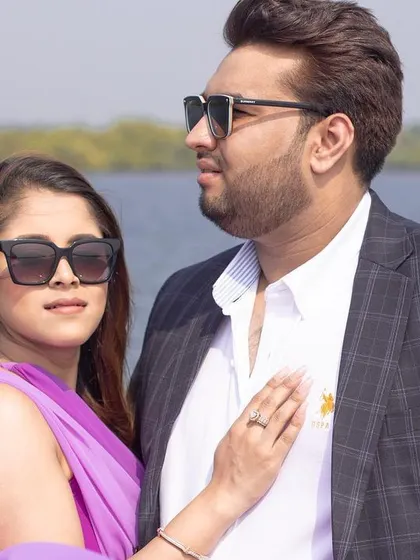 A close-up, loving portrait of the couple on their Goan yacht adventure, capturing their connection and the beautiful seaside light.