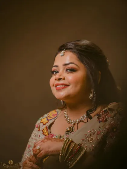 A warm and intimate portrait of the bride. The soft lighting and her happy expression make this a beautiful and personal shot.