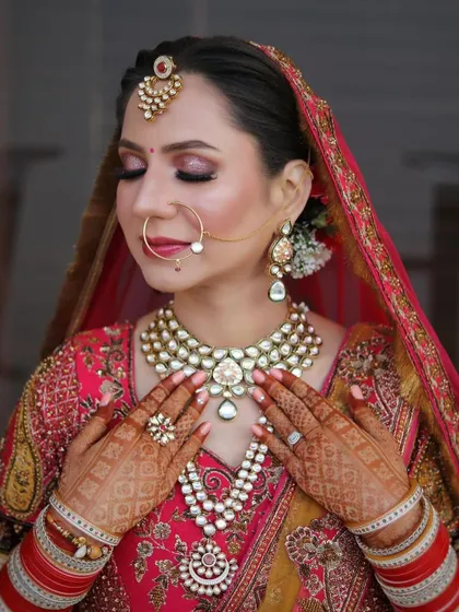 A serene portrait with eyes closed, showcasing the soft pink and gold eyeshadow work and the flawless base makeup.
