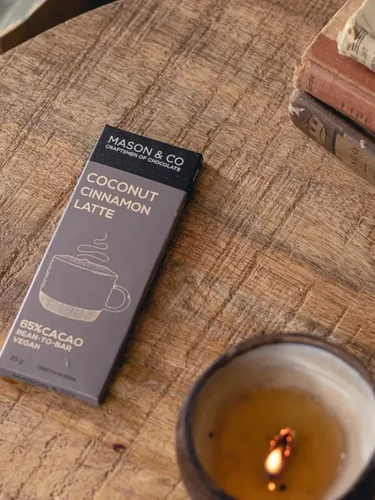 The chocolate bar on a wooden table, creating a warm, inviting scene. It’s a product that perfectly represents our blend of coffee culture and artisanal goods.