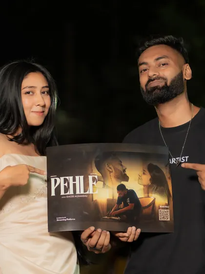 Holding the official poster for my single 'Pehle' with the female lead from the music video. This behind the scenes shot celebrates the team effort that goes into creating a music video.