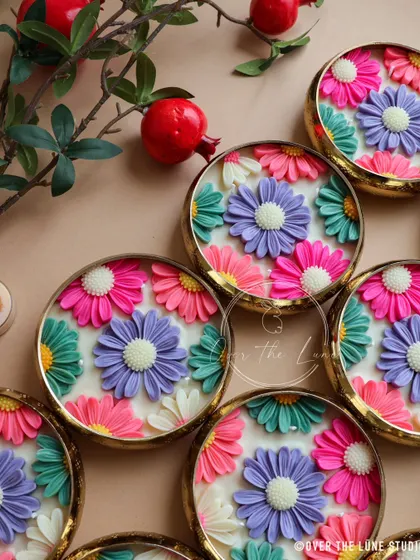 A closer look at the vibrant, multi-colored daisy urlis I created for a Mehendi function. The combination of pink, purple, and teal flowers makes for such a joyful and festive decorative piece.