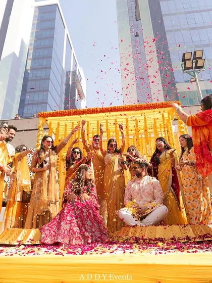 A Haldi ceremony is all about joy and vibrancy. We love creating fun, interactive moments like this petal shower, set against a backdrop of traditional marigolds for the perfect blend of tradition and fun.