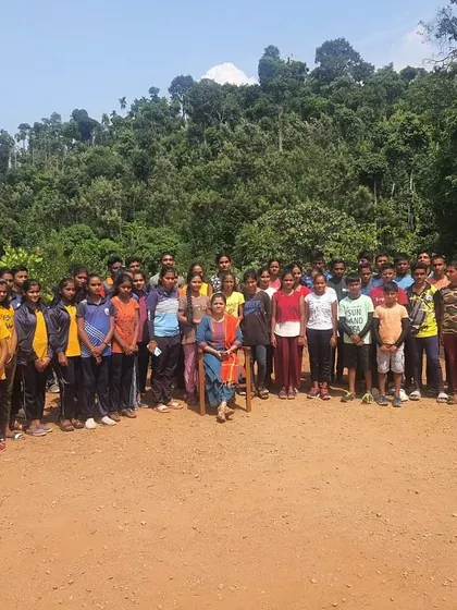 A large group of students from the KRIES summer camp gathers for a photo at our Barapole center.